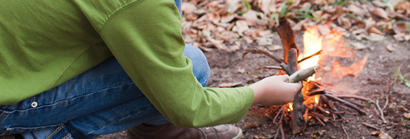 Young person starting a fire